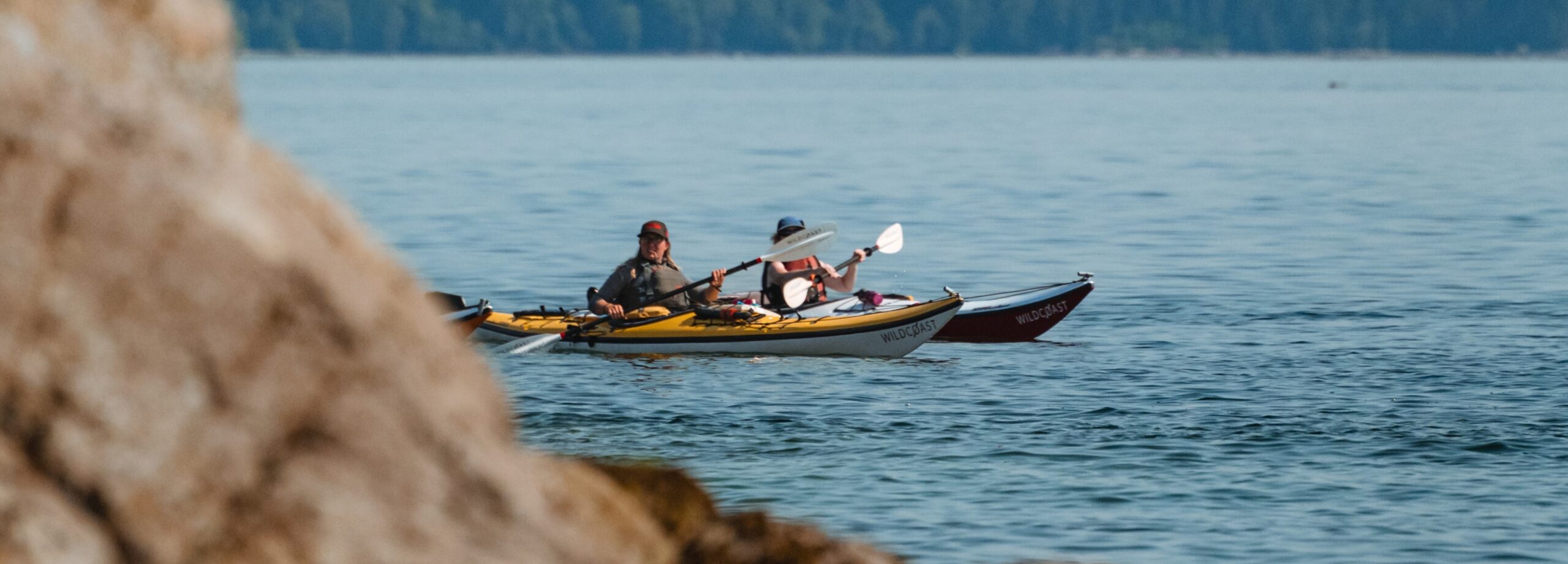 a group of kayakers in the ocean